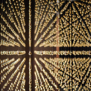 Arin Rungjang, 'Golden Teardrop', View 2, 2013, Steel frame, 6,000 suspended brass teardrops, 30 minute single channel video, Image courtesy of Singapore Art Museum