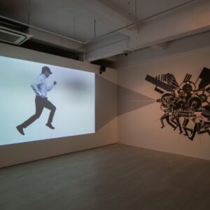 Victor-Balanon-’The-Man-Who’-2017,-single-channel-video-projection-with sound,-and site-specific wall painting.-Photo-courtesy-of-Artsy